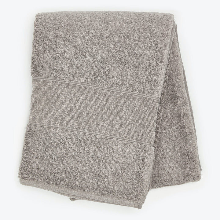 Soft, fluffy gray bath towel with decorative texture bands folded.