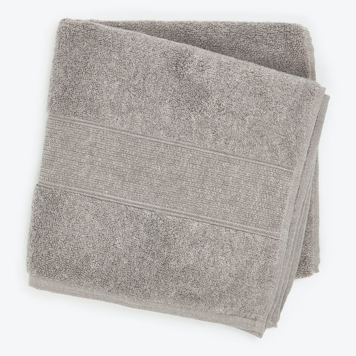 Soft and absorbent light grey bath towel with textured design.