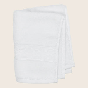 Soft plush grey towel with textured band, isolated on white. - hover