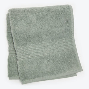 Soft, fluffy light green bath towel with decorative border folded.