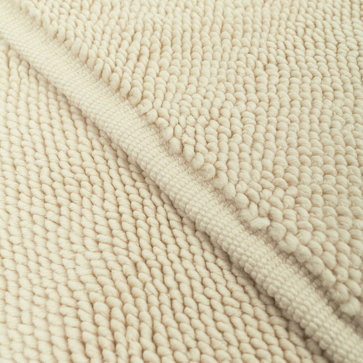 Close-up of beige plush pile fabric with distinctive woven pattern.