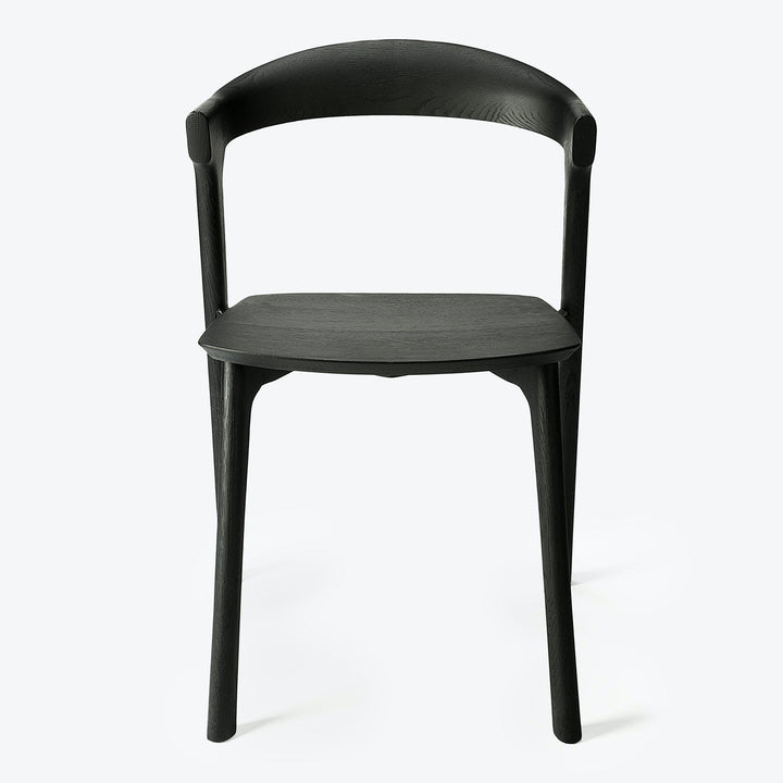 Modern black chair with curved backrest and wood grain texture