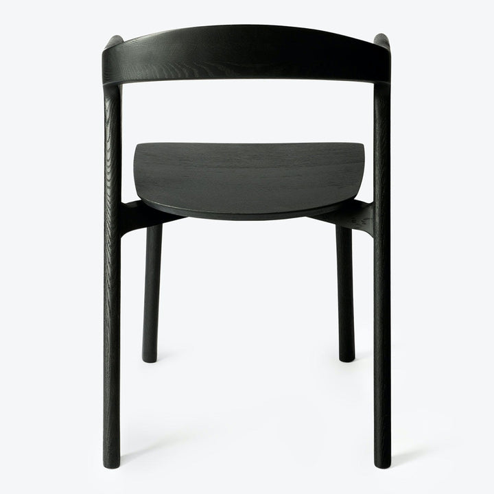 Modern black chair with curved backrest and textured seat design