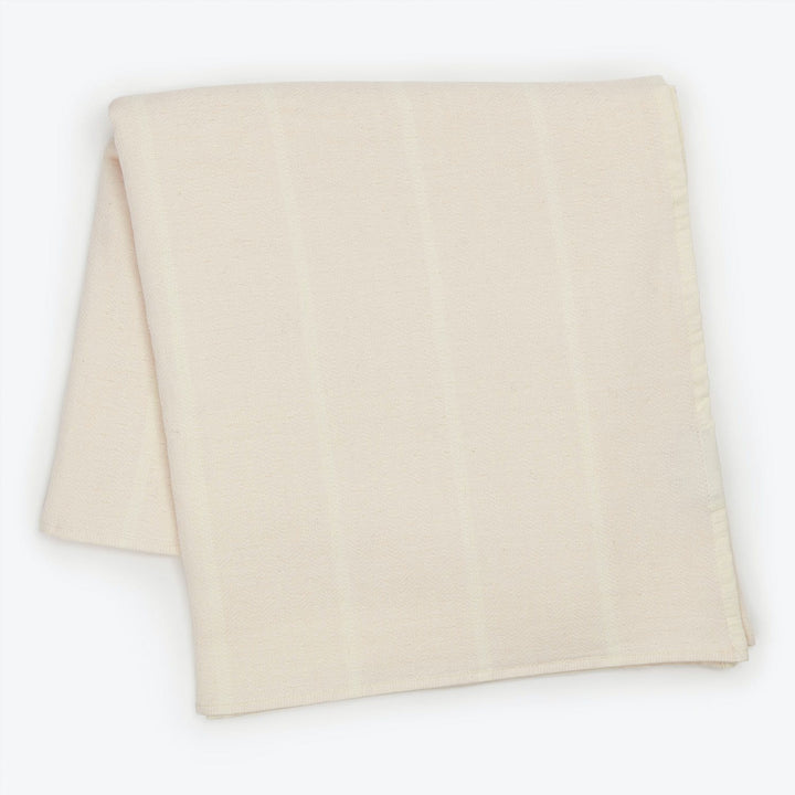 Light-colored fabric with subtle stripes neatly folded on white background.