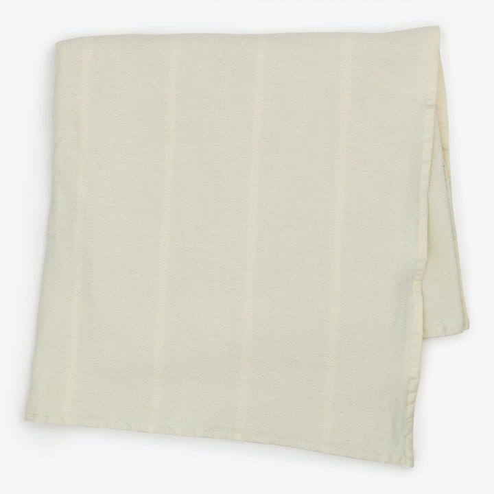 Soft, textured fabric with visible folds against monochromatic background.