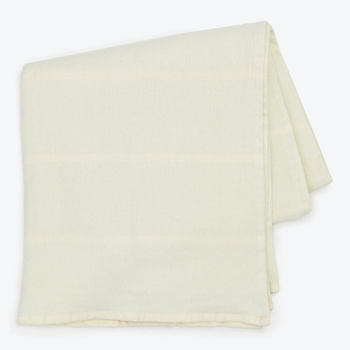 Folded light fabric on white background, soft and smooth texture.