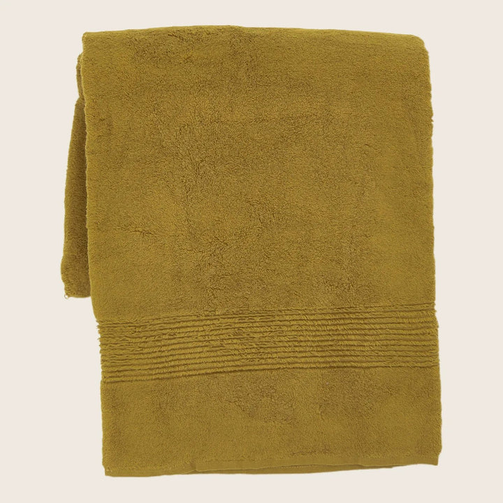 Olive green plush towel with decorative border on white background