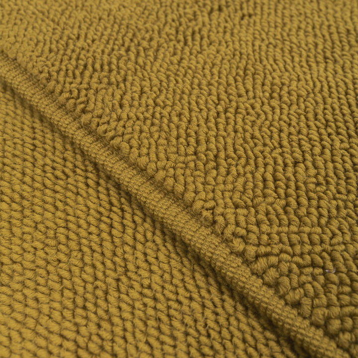 Mustard yellow chunky knit fabric with intricate three-dimensional texture.