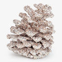 Shiny silver glitter decorates festive pine cone for holiday season.