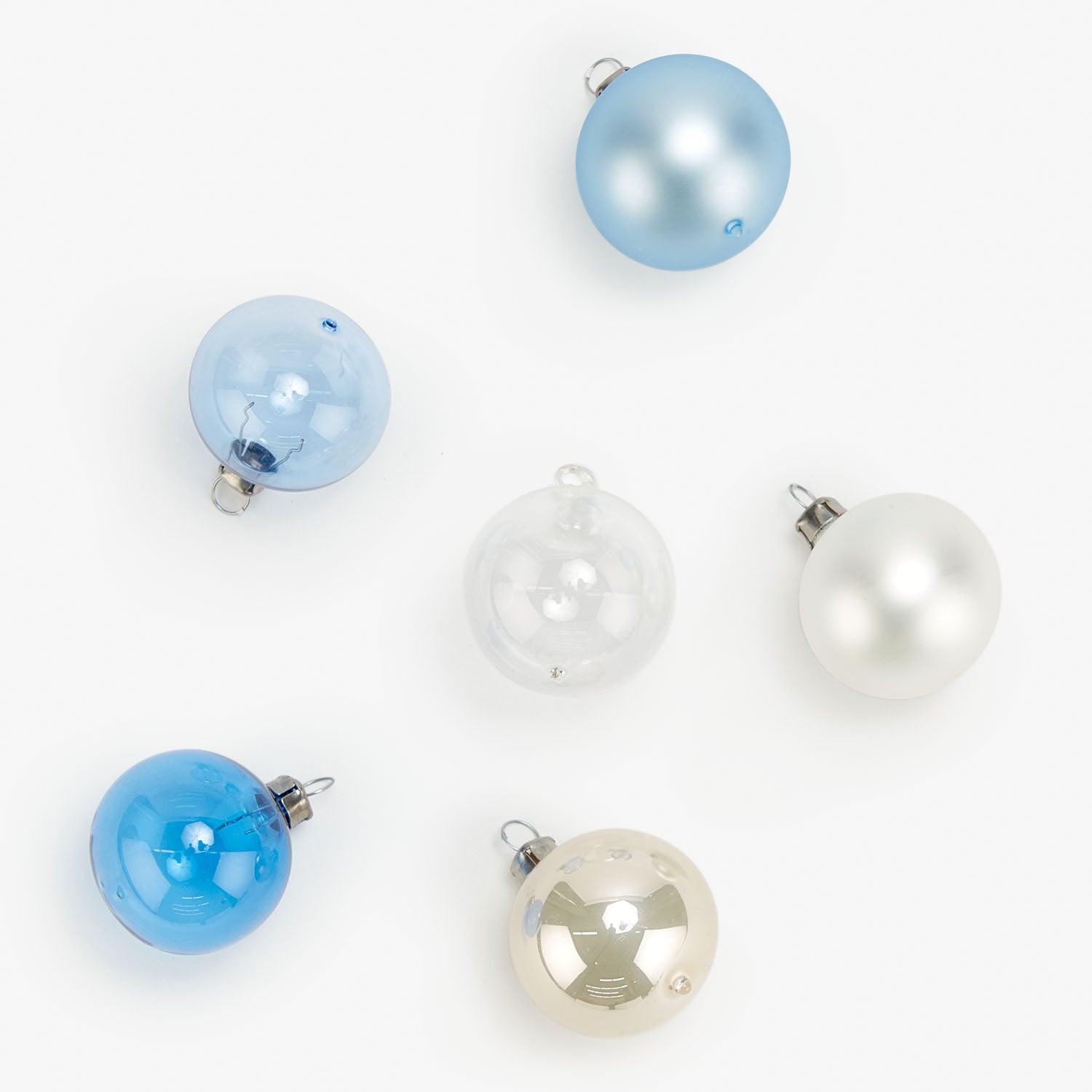 Six spherical Christmas ornaments in shades of blue and white.