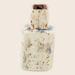 Unique ceramic vase with irregular shape and rustic glazing process.
