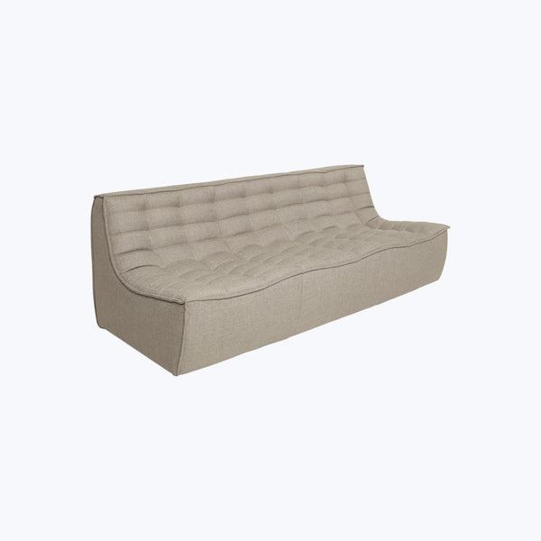 Contemporary minimalist sofa with tufted design in neutral beige color.