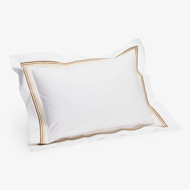 Elegant rectangular pillow with gold-brown border, soft and comfortable.