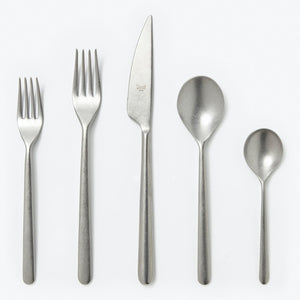 Five pieces of flatware in sleek brushed metal design set. - hover