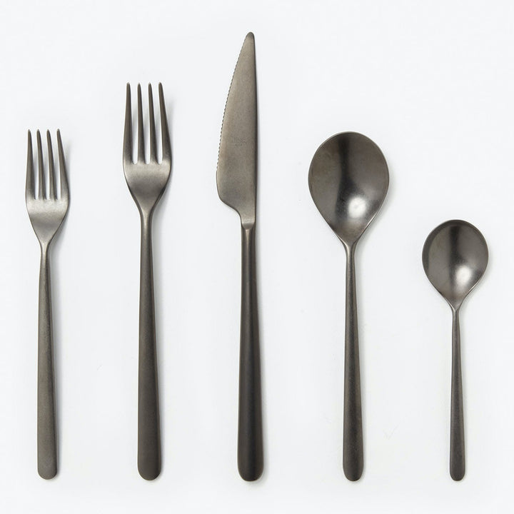 Modern dark gray cutlery set with sleek design on light background.