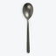 Single metal spoon with oval bowl on white background.