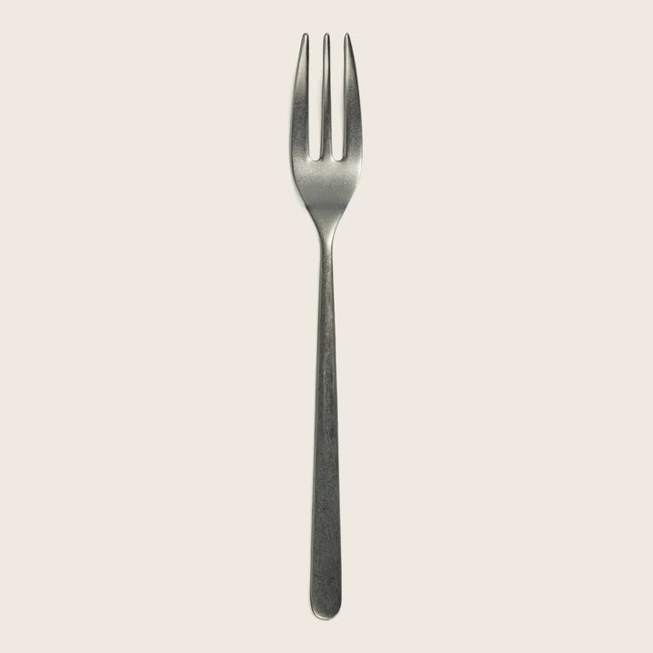 Classic metal fork with matte finish on white background, symmetrical.