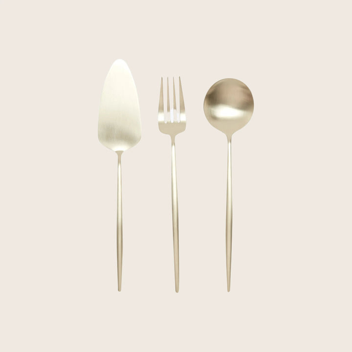 Three elegant stainless steel cutlery pieces on white background
