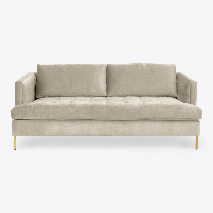 Modern-style sofa with neutral upholstery, tufted seat, metallic legs.