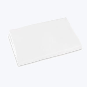 Crisp, white bed sheets neatly stacked in minimalist setting. - hover
