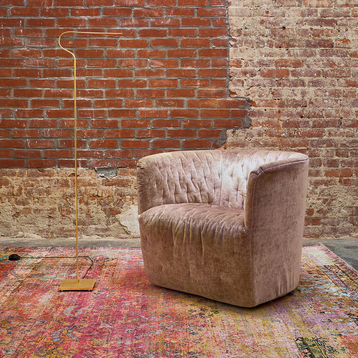 Luxurious armchair with floor lamp in modern-industrial interior setting.