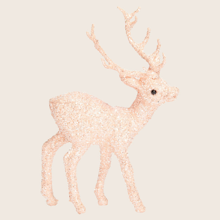 Festive glittery reindeer figurine in peach color for Christmas decor.