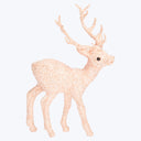 Festive glittery reindeer figurine in peach color for Christmas decor.