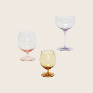 Empty red wine glass with elegant design against white background. - hover