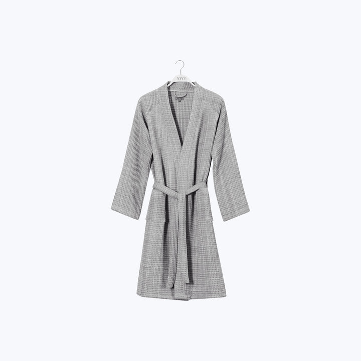 Grey herringbone bathrobe with shawl collar on white hanger.