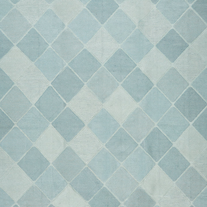 Textured fabric with repeating diamond pattern in shades of blue