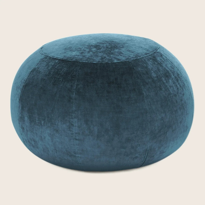 Teal velvet pouf, a stylish and versatile home decor item.
