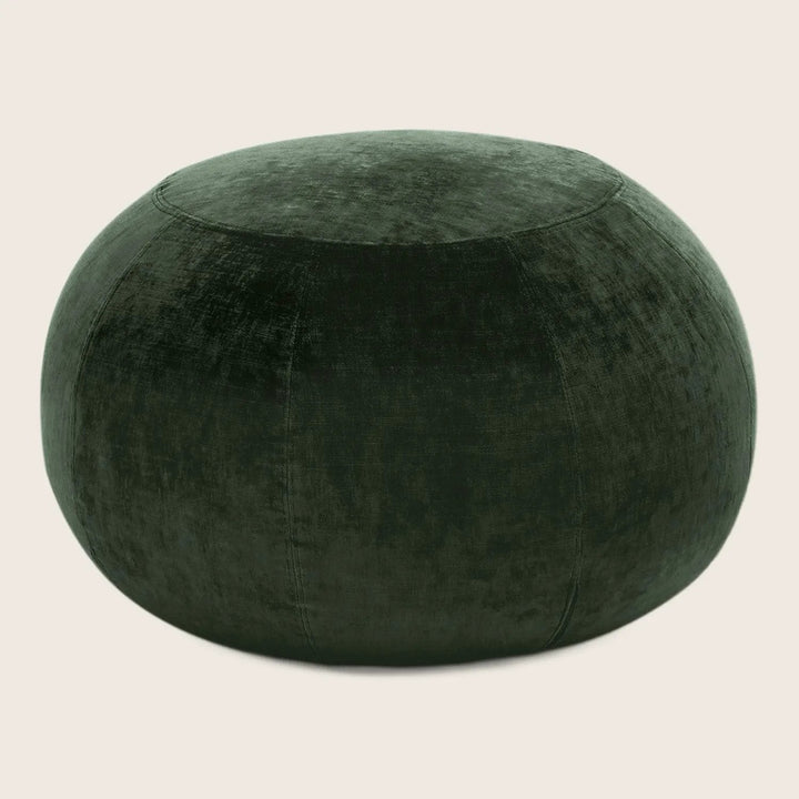Dark green velvet ottoman adds a touch of elegance.