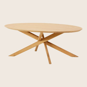 Modern wooden table with a round natural top and X-shaped base. - hover