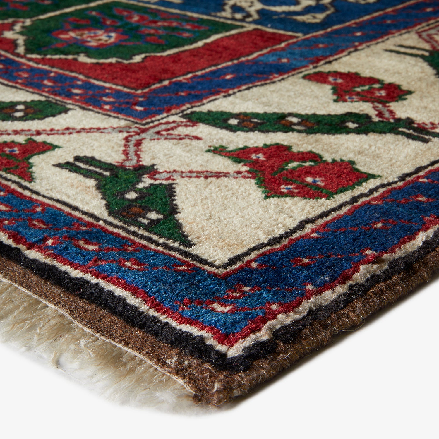 Close-up of ornate, colorful area rug with intricate patterns.