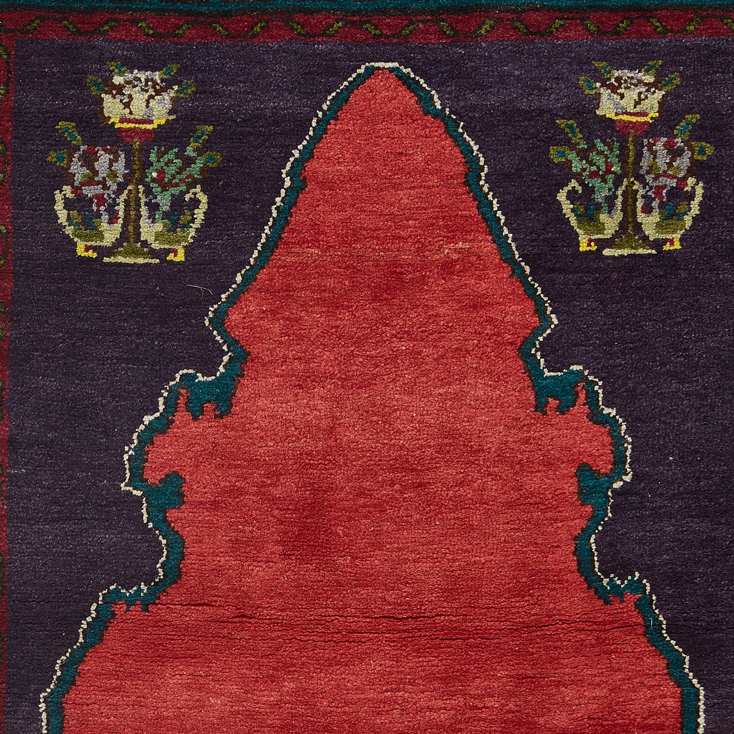 Intricate rug with traditional Islamic design in rich colors.