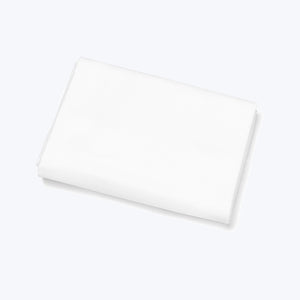 Folded white fabric against white background, creating shadows and depth.