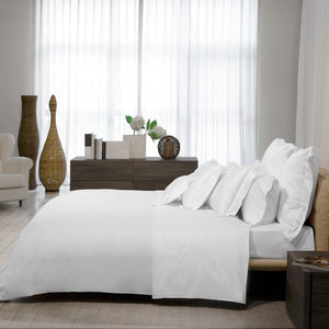 Folded white fabric against white background, creating shadows and depth. - hover
