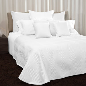 Two white herringbone quilted pillows on white background. - hover