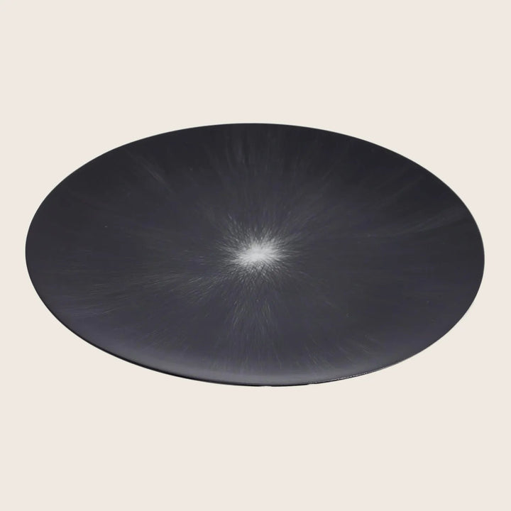 Modern minimalist plate with sunburst effect on white background.