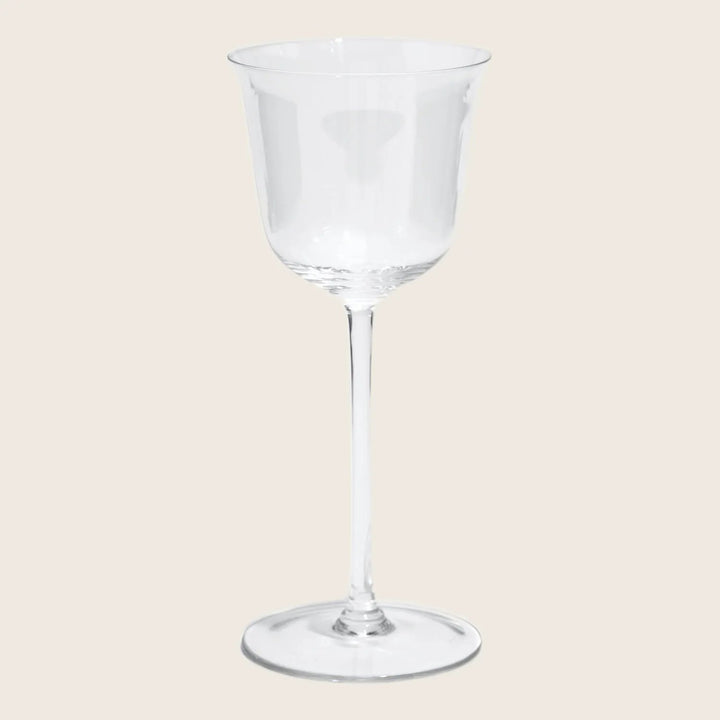 Clear glass wine goblet on white background, traditional design.