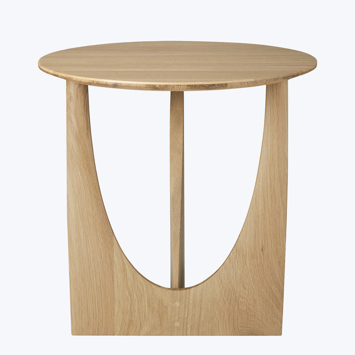 Modern wooden table with minimalistic design, round tabletop and curved support.