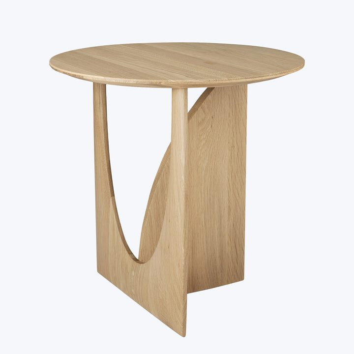 Sleek modern round table with unique boomerang-shaped base design.