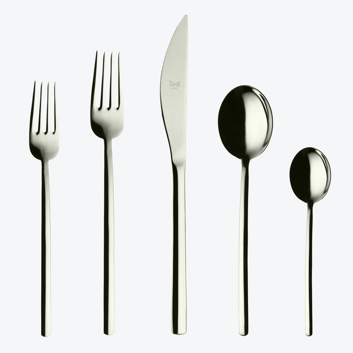 Modern silverware set arranged on light background, highly polished design.