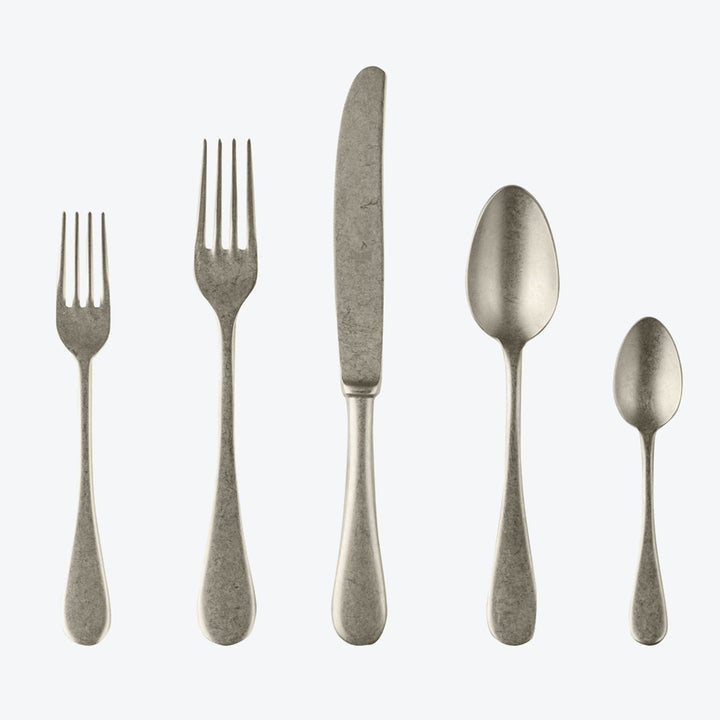 Set of five matching stainless steel cutlery pieces in line.