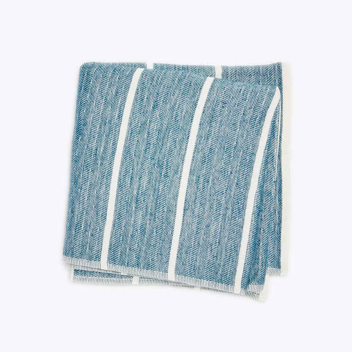 Neatly folded blue and white striped towel with visible fringes.