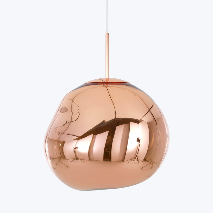 Modern, copper pendant light with reflective, distorted surface, sleek design