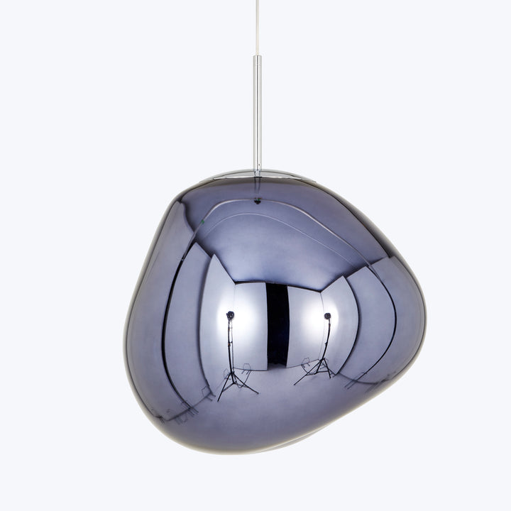 Sleek, reflective pendant light with unique curvilinear shape in studio.