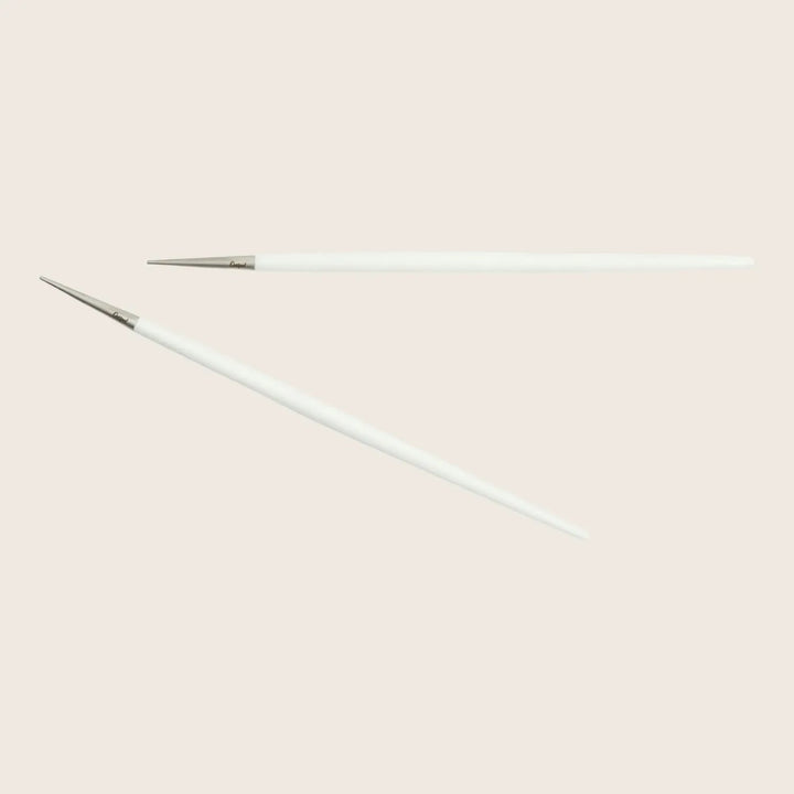 One intact and one broken knitting needle on white background.