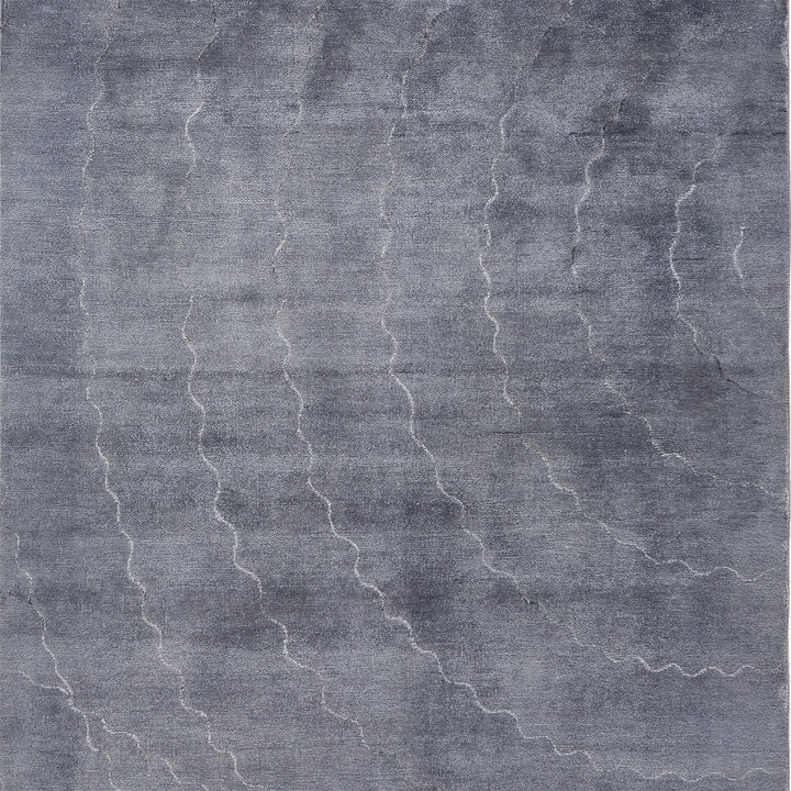 Monochromatic textured fabric with abstract lightning-like pattern in gray tones.