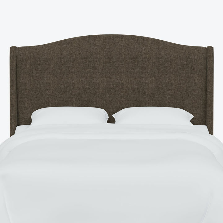 Minimalist bedroom with neatly made bed and symmetrical upholstered headboard